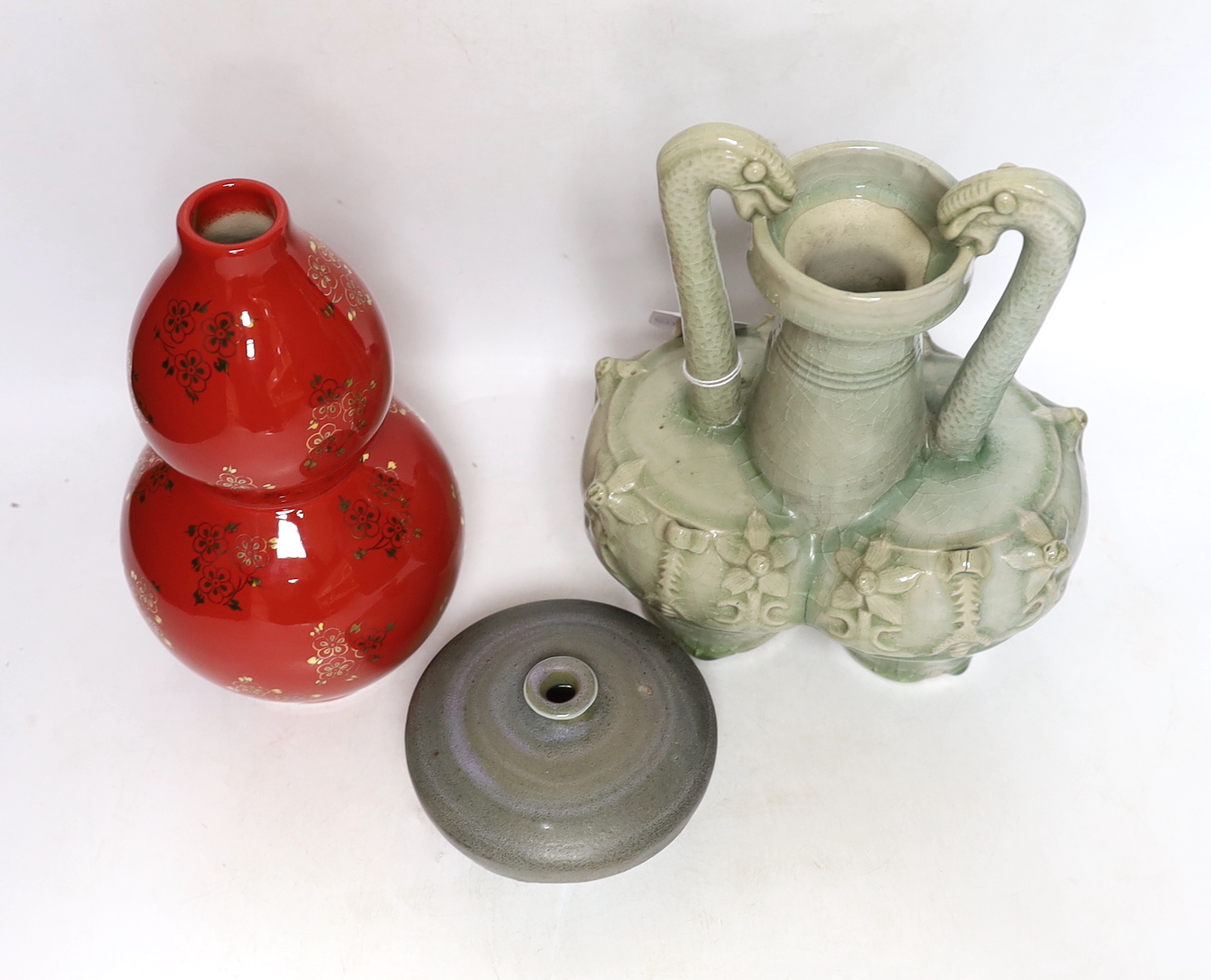 A Chinese red ground vase, Chinese celadon conjoined dragon handled vase and a studio pottery vase, 25cm